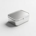 Rectangular silver metal box with a hinged lid resting on a white surface Royalty Free Stock Photo