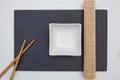 Rectangular slate plate with chopsticks, bamboo mat  for sushi on the white table Royalty Free Stock Photo