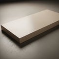 A rectangular smooth beige block with sharp edges resting on a textured Royalty Free Stock Photo