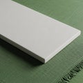 A rectangular, smooth-surfaced white slab displayed on a textured green fabric. The Royalty Free Stock Photo
