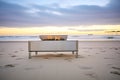 rectangular stainless steel fire pit on a beach at dusk Royalty Free Stock Photo