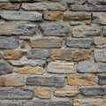Rectangular stones in shades of grey and brown form a dry stone wall pattern. Each Royalty Free Stock Photo