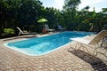 Rectangular swimming pool with deck chairs