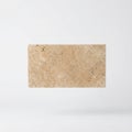 Rectangular textured beige travertine stone slab isolated on white background Royalty Free Stock Photo