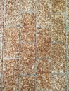 Tiled surface in brown and beige tones with random pattern. Royalty Free Stock Photo