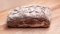 Rectangular wheat rye bread on a wooden board.