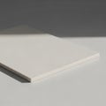 A rectangular white block or slab is placed on a light gray surface. The ob Royalty Free Stock Photo
