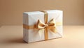 Rectangular white box gift wrapped with gold satin ribbon and bow. Minimalist presentation on neutral surface, ready for special Royalty Free Stock Photo
