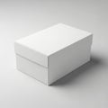 Rectangular white box with a lid, positioned on a light gray surface. The box appears to be made of Royalty Free Stock Photo