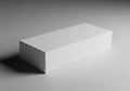 Rectangular white box placed on a smooth, light gray surface. The box Royalty Free Stock Photo