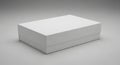 Rectangular white cardboard box with a simple design, resting on a smooth, neutral gra Royalty Free Stock Photo