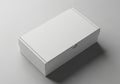 Rectangular white cardboard box with a smooth surface, resting on a light gray Royalty Free Stock Photo
