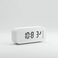 Rectangular white digital clock displaying \