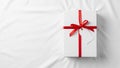 A rectangular white gift box rests on a smooth white surface Royalty Free Stock Photo