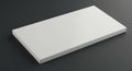 Rectangular white slab or tile placed on a dark surface. The object features a
