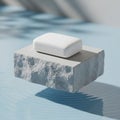 A rectangular white soap bar rests atop a textured gray stone block Royalty Free Stock Photo