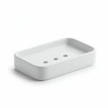 Rectangular white soap dish with a simple design, featuring rounded edges and three Royalty Free Stock Photo