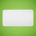 Rectangular white sponge with rounded corners on a vibrant green background Royalty Free Stock Photo