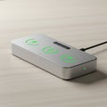Rectangular wireless charging pad with a sleek metallic finish, featuring glowing green Royalty Free Stock Photo