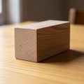 Rectangular wooden block positioned on a smooth, light-colored wooden table. The block features Royalty Free Stock Photo