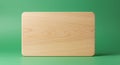 Rectangular wooden board with rounded corners set against a solid green background. Royalty Free Stock Photo
