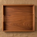 Rectangular wooden tray with a rich brown finish, featuring subtle grain patterns. It ha Royalty Free Stock Photo