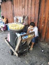 Recto, Manila, Philippines - A sidewalk vendor selling steamed corn in front of a closed shop Royalty Free Stock Photo