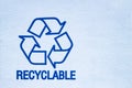 Recyclable symbol on a white cardboard Royalty Free Stock Photo