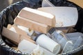 Recyclable waste in a container. Cardboard boxes, paper, bottles and plastic containers in an outdoor container for Royalty Free Stock Photo