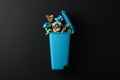 Recycle bin with trash on black background Royalty Free Stock Photo