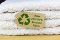 Recycle clothes icon on recycled card label, made with 100% Recycled fabric text. Sustainable fashion