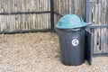 Recycle food black and green bin set at corner over bamboo wall for recycling