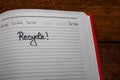 Recycle, handwriting text on page of office agenda. Copy space