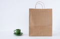 recycle shopping bag next to cup of coffee on the table and white background