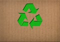 Recycle symbol on cardboard texture Royalty Free Stock Photo