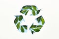 Recycle symbol made of cut paper and green leaves on blue background. Reuse, reduce, recycle concept Royalty Free Stock Photo