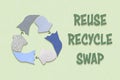 Recycle textiles symbol made from old clothing fabric on green background Royalty Free Stock Photo