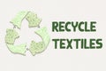 Ecycle textiles symbol made from old clothing fabric on recycled card, with text Royalty Free Stock Photo