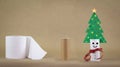 Recycle toilet roll tube, decorated and reused into Christmas tree decoration with smiling face, homemade quirky fun. Royalty Free Stock Photo