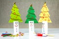 Recycle toilet roll tubes, decorated and reused into Christmas tree decoration with smiling face, homemade quirky fun Royalty Free Stock Photo