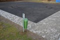 Recycled asphalt crumb is used on the edge of the new cycle path and in the subsoil of the asphalt road. between the field and the Royalty Free Stock Photo