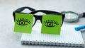 Recycled blank spiral notebook with magnifying glass and reading glasses isolated on background. concept of night work in the