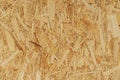 Recycled compressed wood chippings board, strand board close-up, fiberboard texture, wooden background Royalty Free Stock Photo