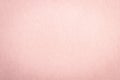 Recycled craft paper textured background in light faded pale pink color