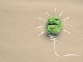 Recycled paper background with green crumpled paper ball as light bulb, ecology concept, innovations, renewable energies Royalty Free Stock Photo