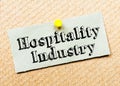 Recycled paper note pinned on cork board. Hospitality Industry Message Royalty Free Stock Photo