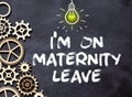 Recycled paper note pinned on cork board.I'm on Maternity Leave Message Royalty Free Stock Photo