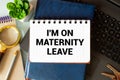 Recycled paper note pinned on cork board.I'm on Maternity Leave Message Royalty Free Stock Photo