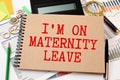 Recycled paper note pinned on cork board.I'm on Maternity Leave Message. Royalty Free Stock Photo