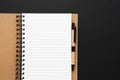 Recycled paper notebook opened on an empty sheet on black background. Copy space, top view Royalty Free Stock Photo